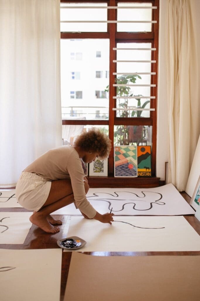 Photo Of Woman Drawing On White Canvass